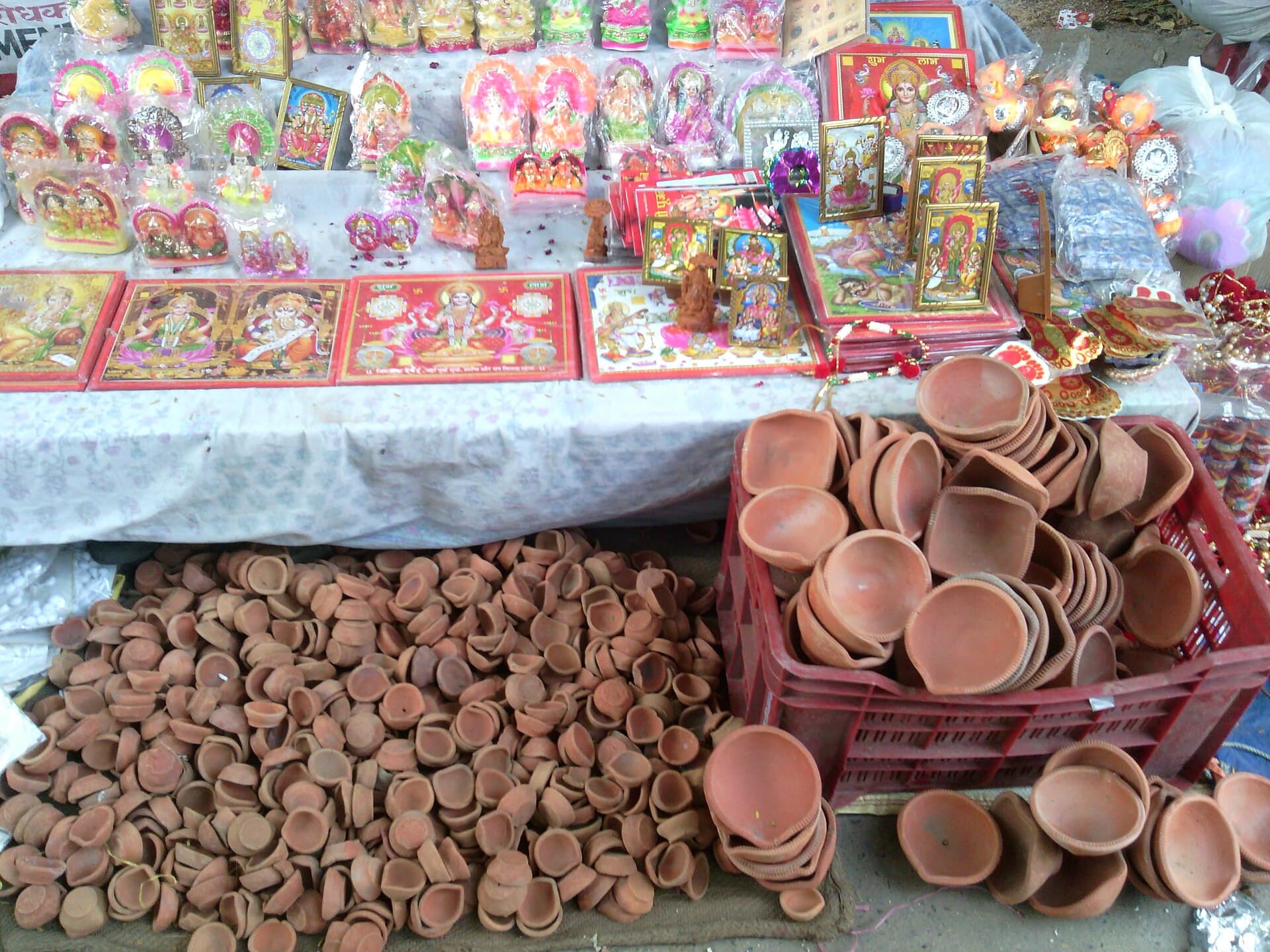 Clay diyas and Diwali goods on sale at an Indian market stall